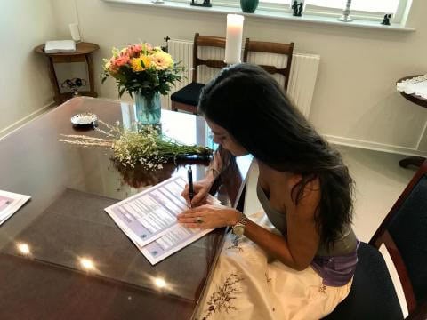 the beautiful bride making her first signature as a married lady